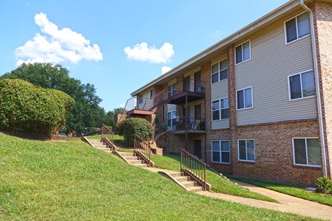 an apartment building on a hill with stairs