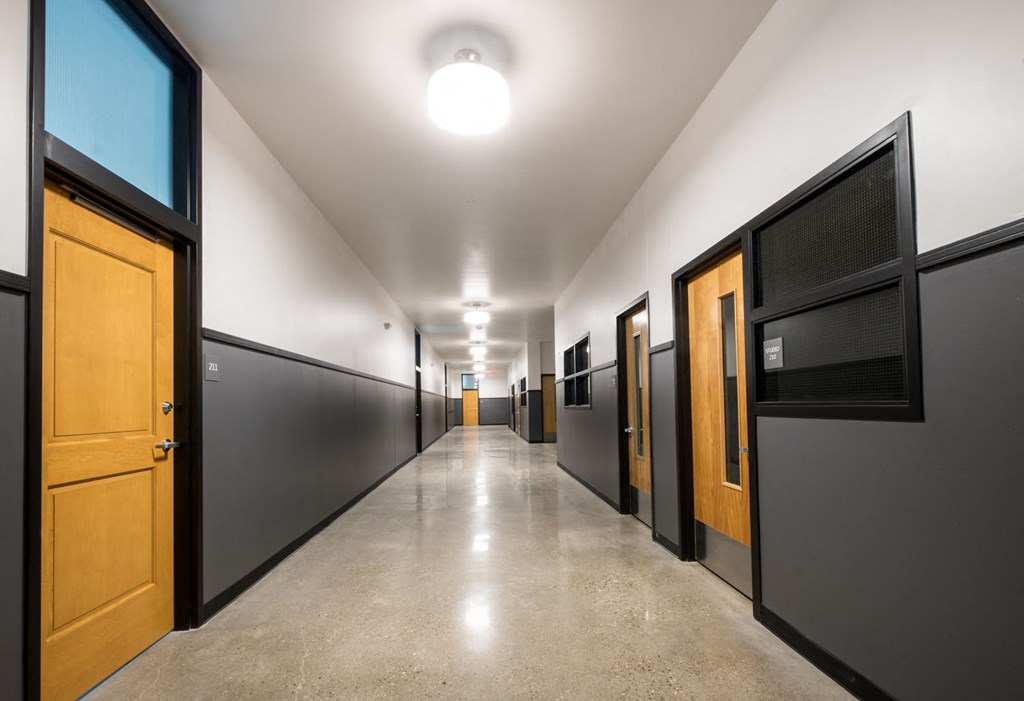 a hallway with black doors and wooden doors