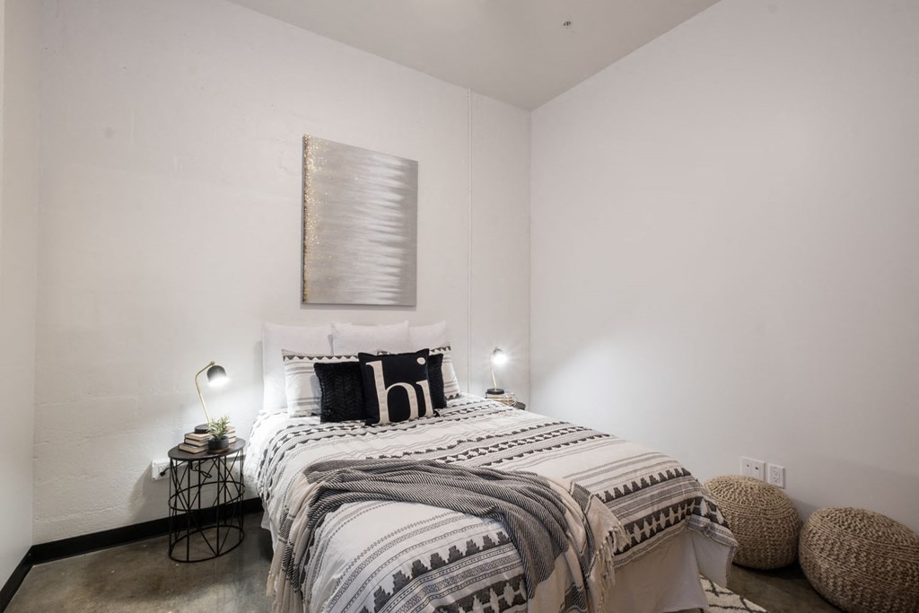 a bedroom with a bed and a painting on the wall