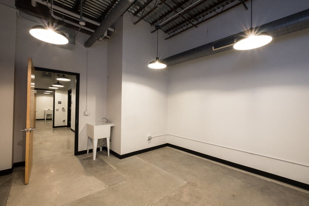 a large office space with white walls and a door to a hallway