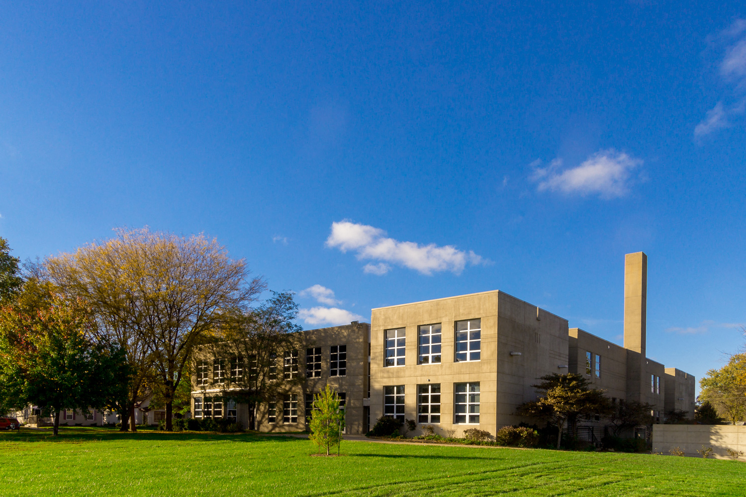 a building with a blue sky and a green lawn