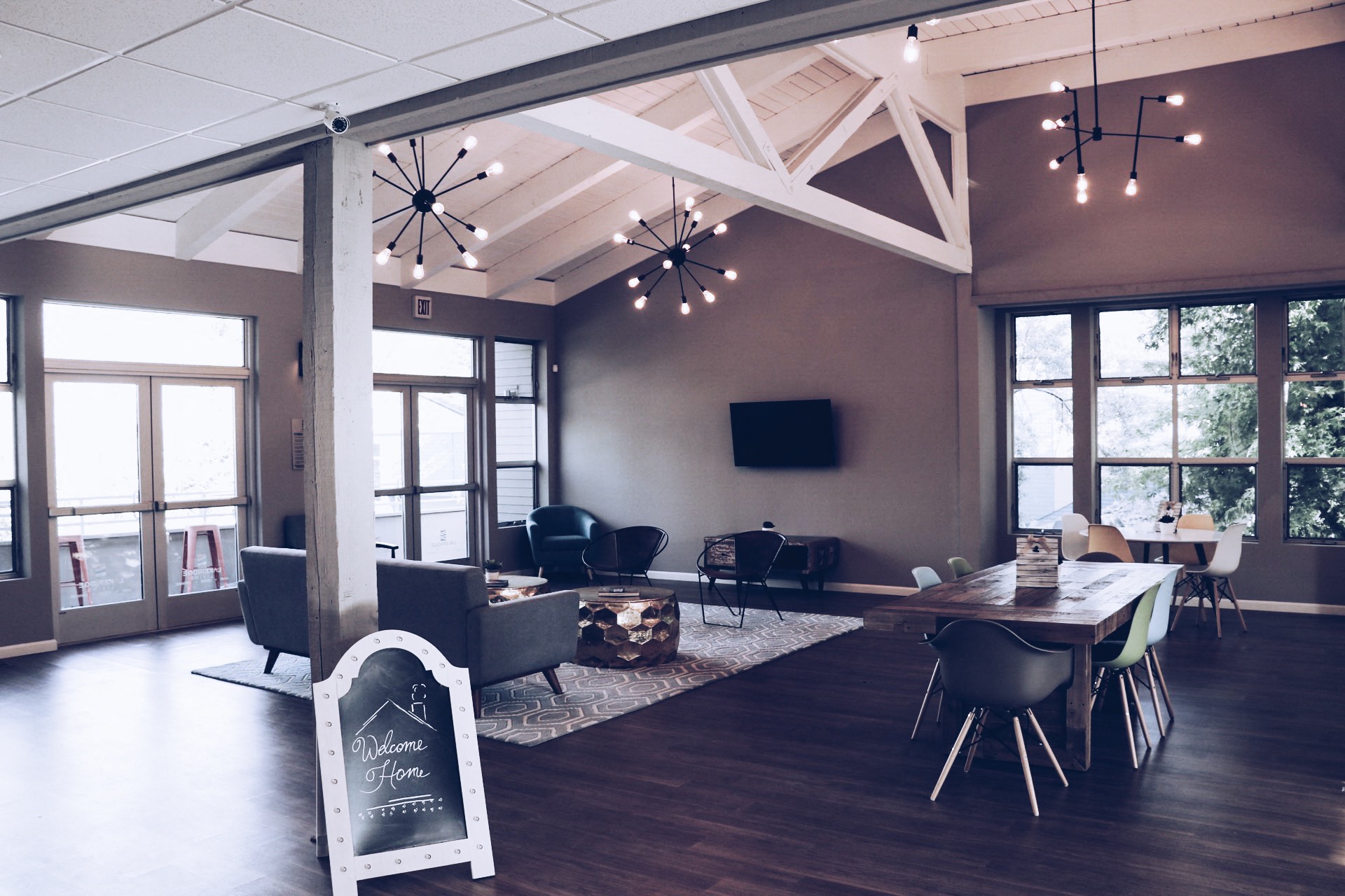 a living room with a table and chairs and a tv