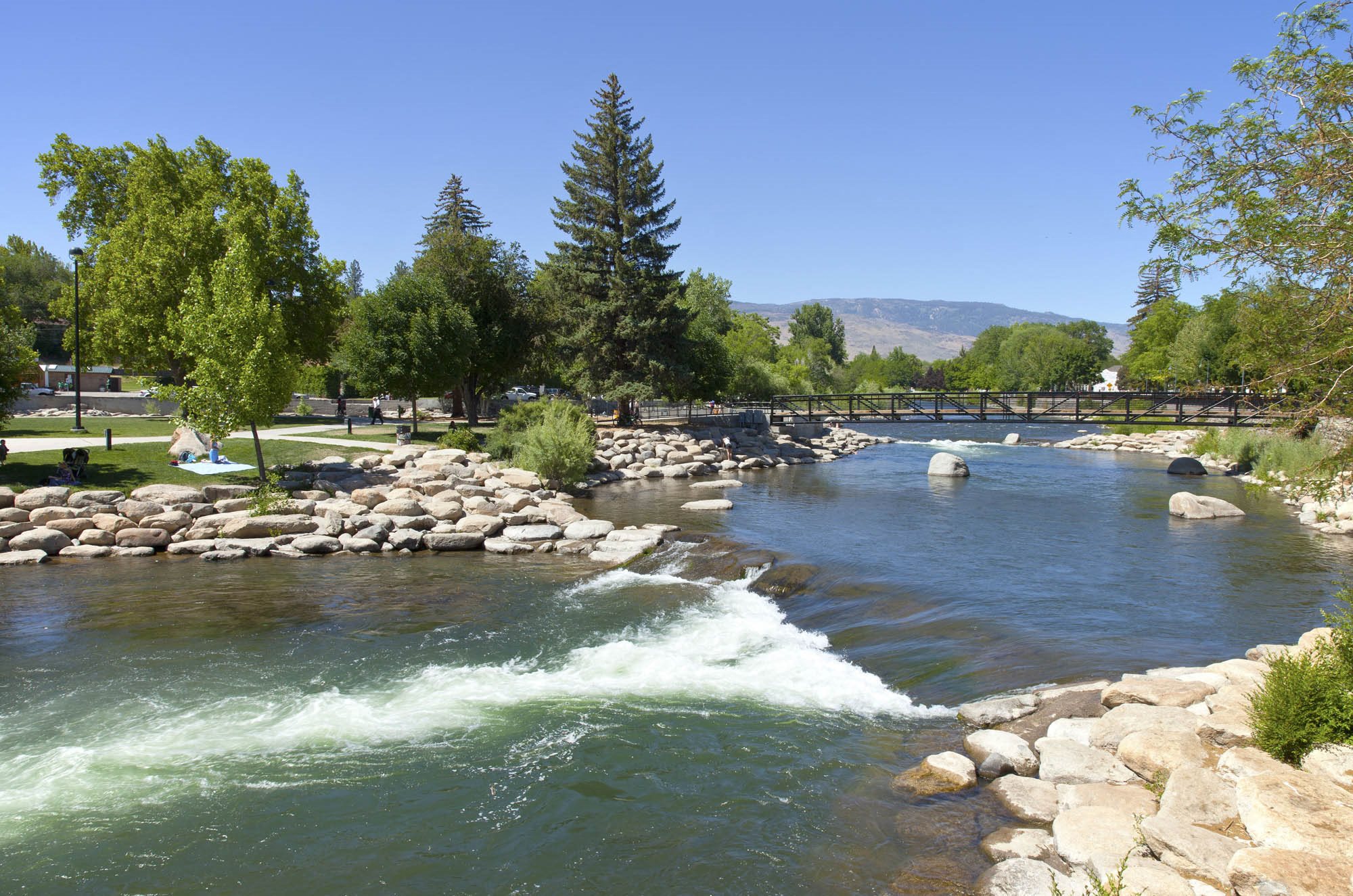 Reno Apartments-Lakeridge Living Apartments Nearby River And Bridge Surrounded By Rocks And Greenery