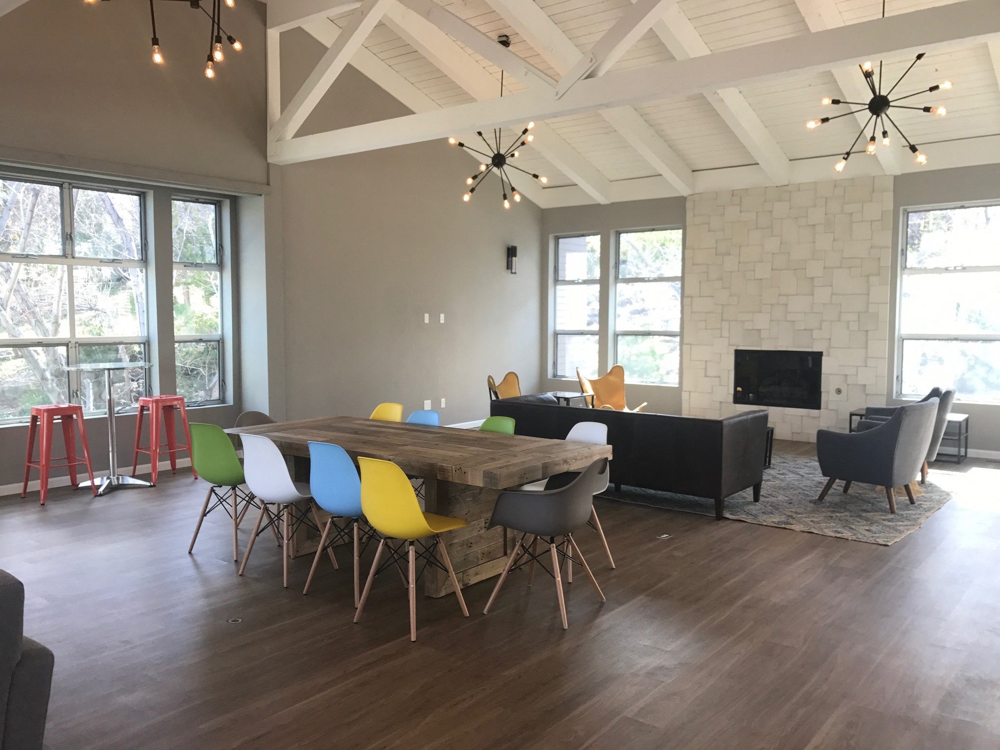 South Reno, NV Apartments - Lakeridge Living Clubhouse with Stylish Decor, Modern Tables and Seating, Fireplace, and Large Windows