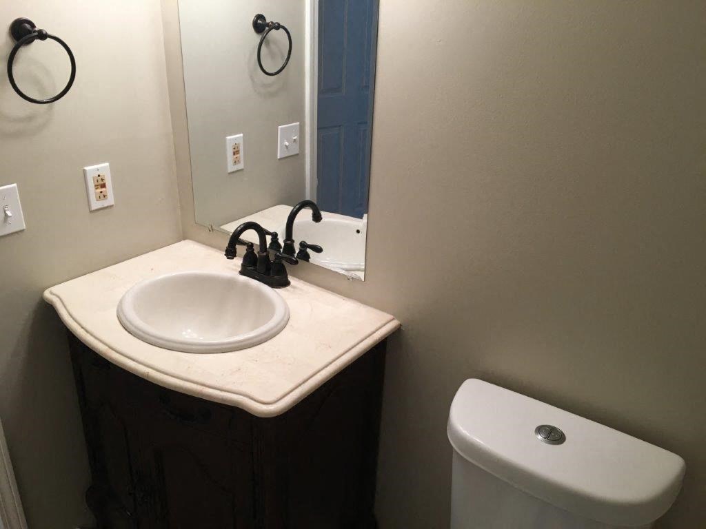 a bathroom with a sink and a toilet and a mirror