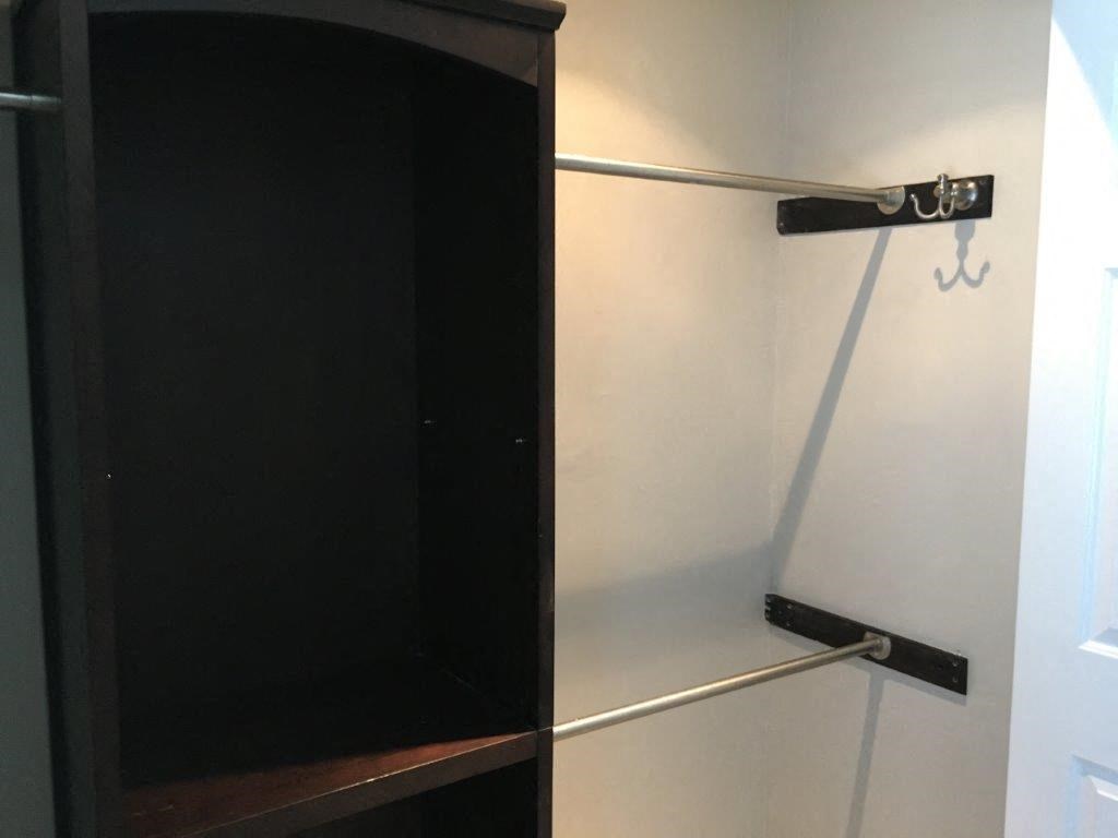 a white refrigerator with a black door in a room