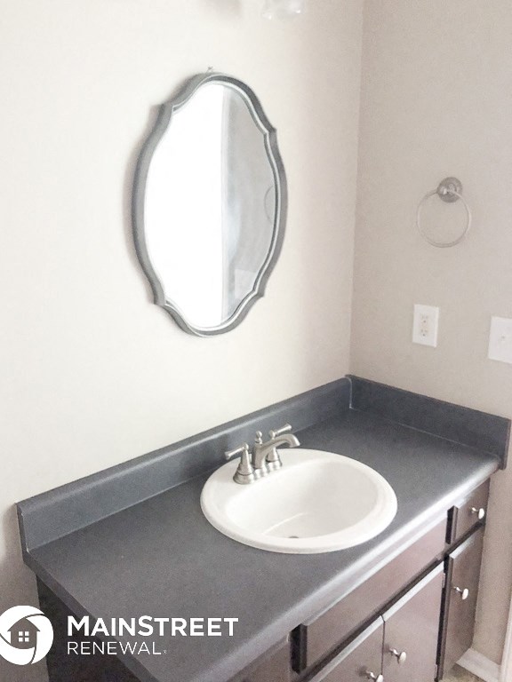 a small bathroom with a sink and a mirror