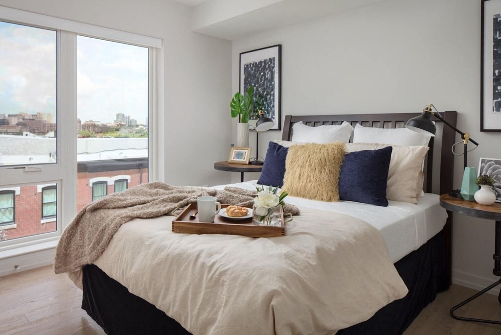 2131 South one bedroom apartment showing queen sized bed and large windows