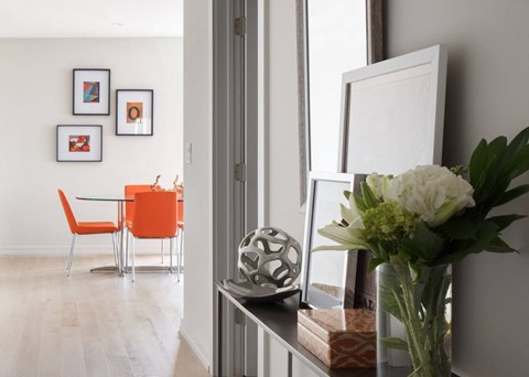 a living room with a table and a vase with flowers