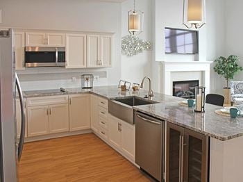 Luxury gourmet kitchens with flat cooktop and beverage center at Residences at Halle, Cleveland, OH