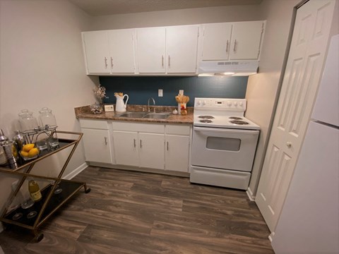 a kitchen with white appliances and white cabinets