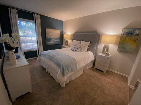a bedroom with a bed and a window