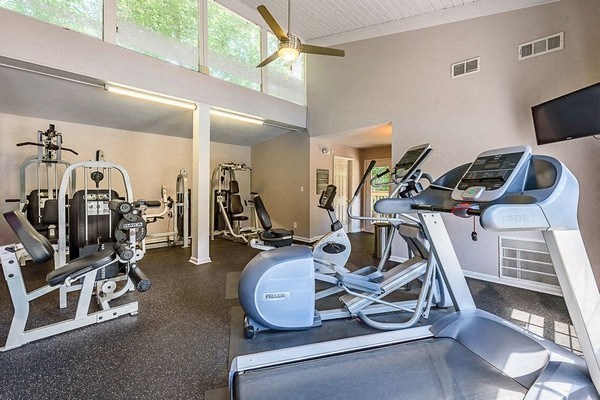 the gym has plenty of exercise equipment and a large window