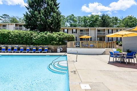 our apartments have a resort style pool with chairs and umbrellas