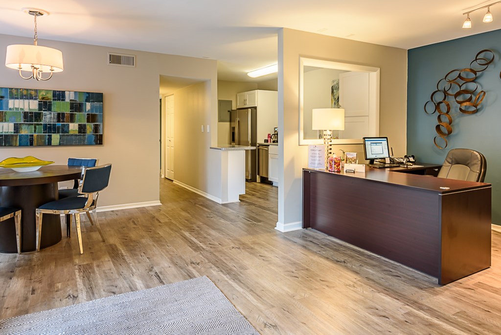 a living room and dining room with a desk and a table