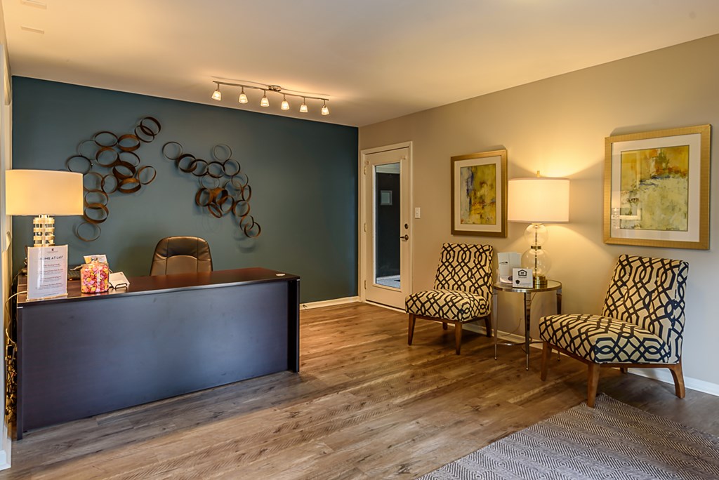 a living room with two chairs and a desk