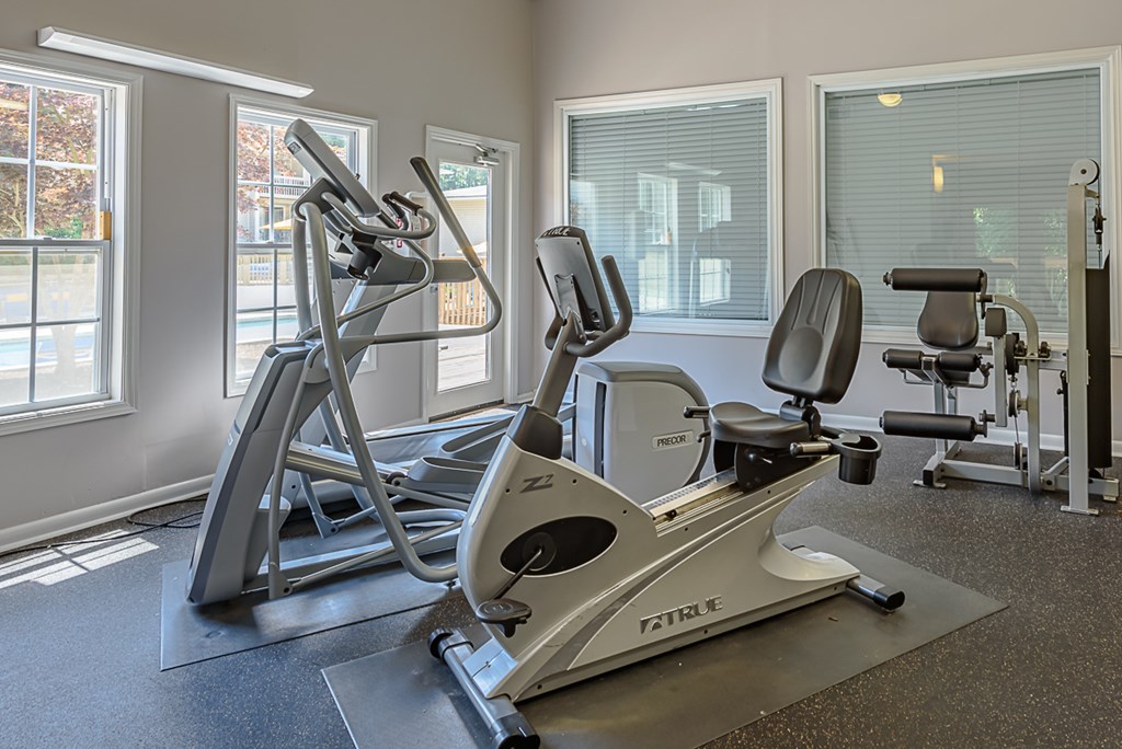 a gym with treadmills and other exercise equipment inside of a building