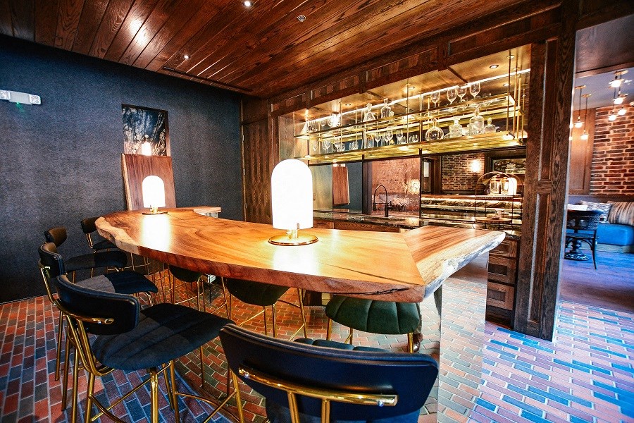 a dining room with a table and chairs and a bar