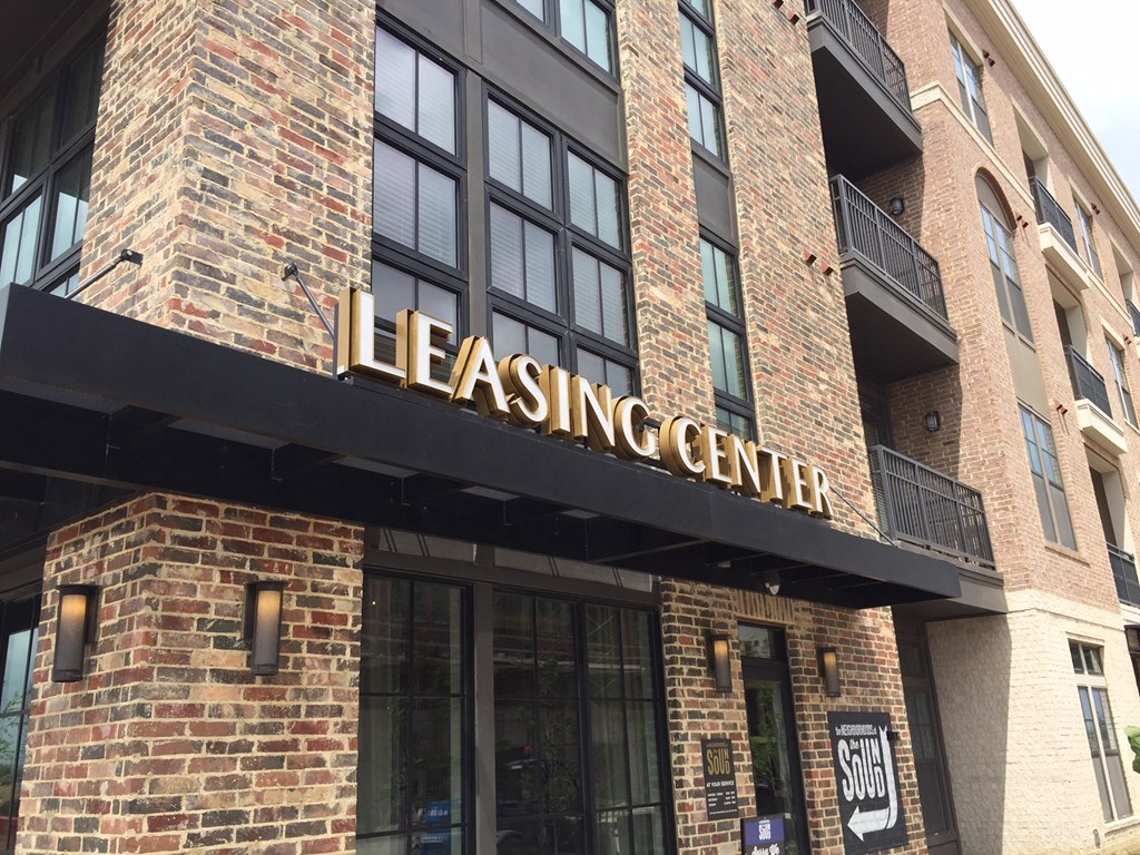 the leasing center on the side of a brick building
