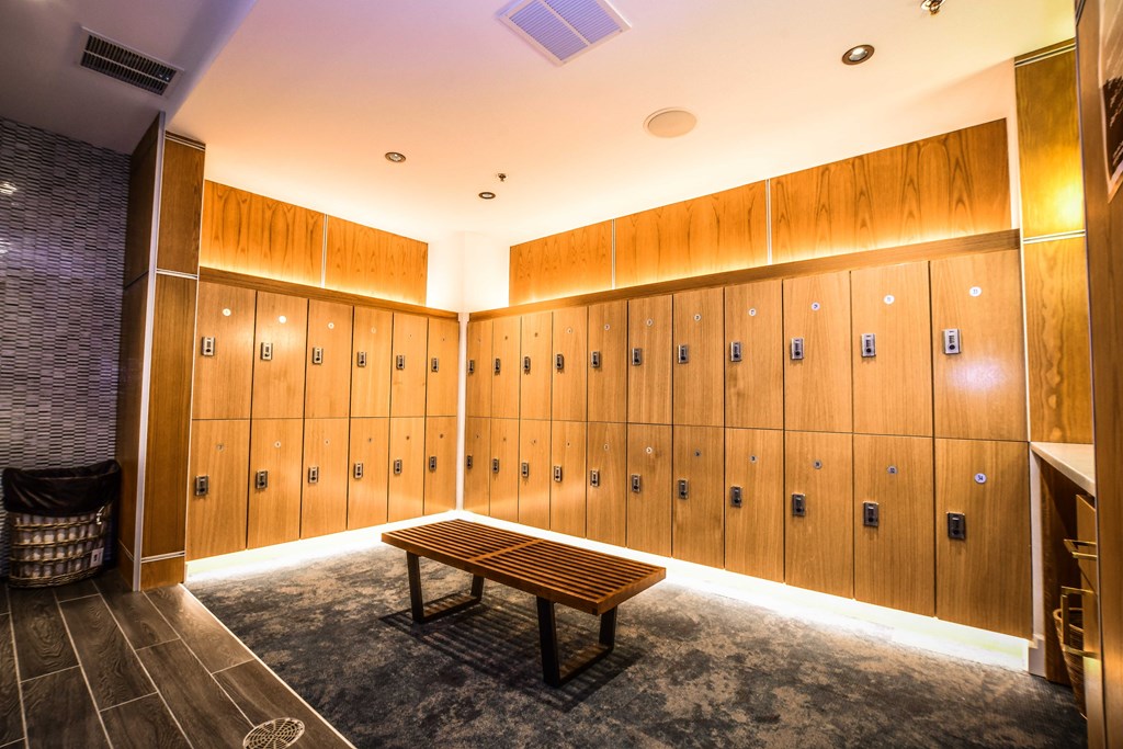 a locker room with wooden lockers and a bench
