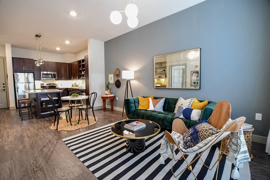 a living room and kitchen with a couch and a table