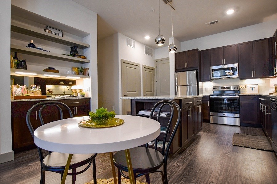 a kitchen and dining room with a white table and chairs
