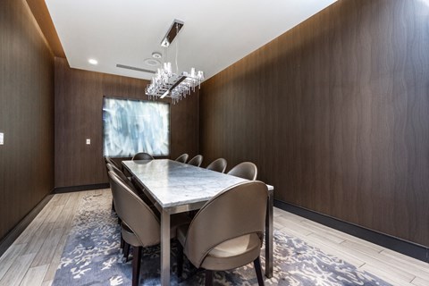 a dining room with a long table and chairs and a chandelier