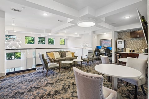 A living room with a white table and chairs.