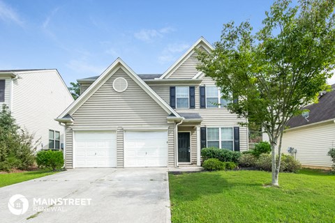 a home with a white garage door in front of it