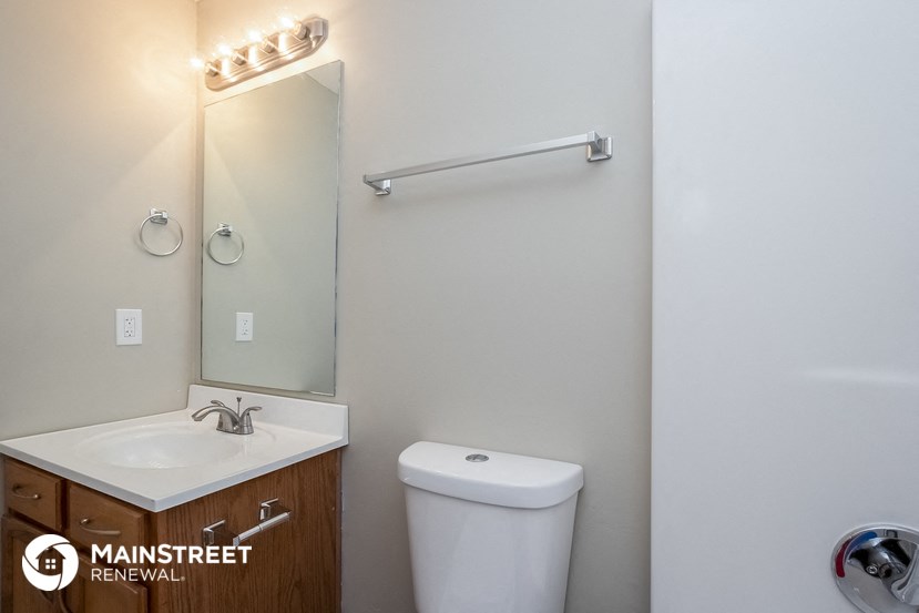 a bathroom with a mirror and a toilet and a sink