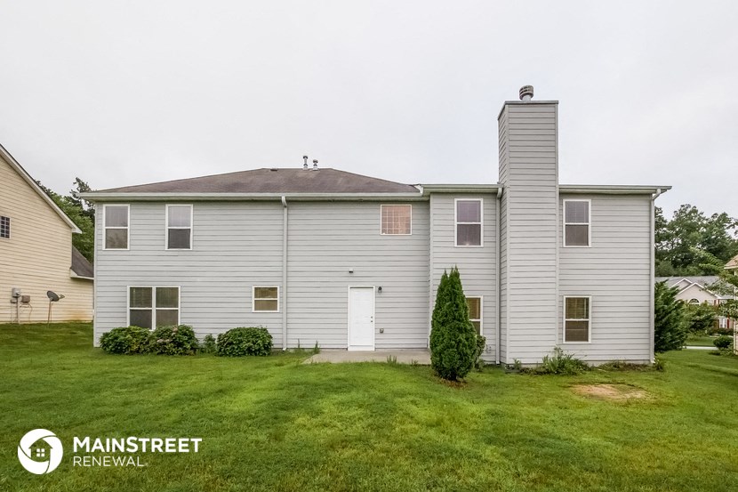 a white house with a lawn in front of it