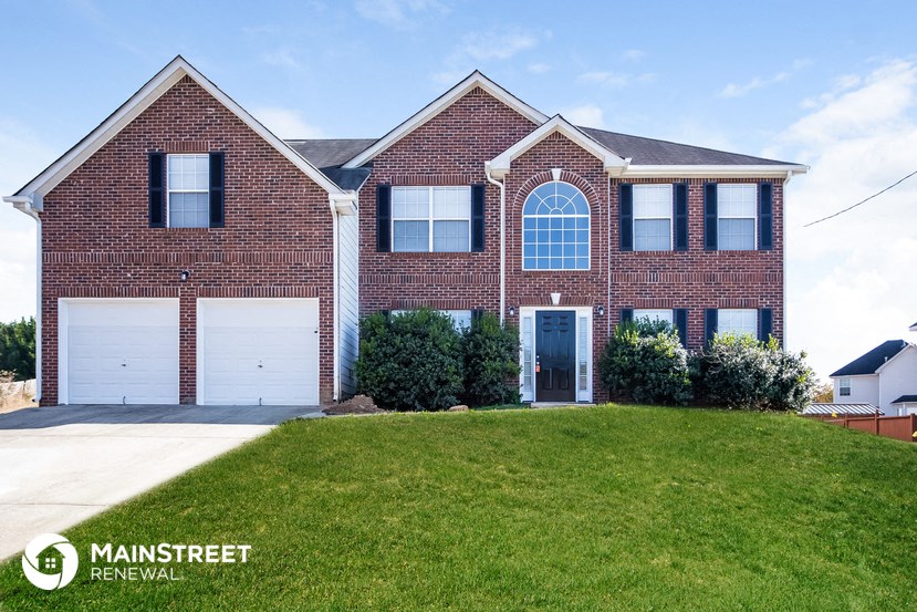 a brick house with a lawn in front of it