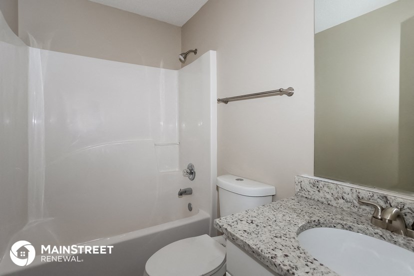 a bathroom with a sink and a toilet and a shower