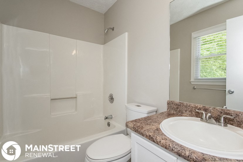 a bathroom with a sink and a toilet and a bath tub