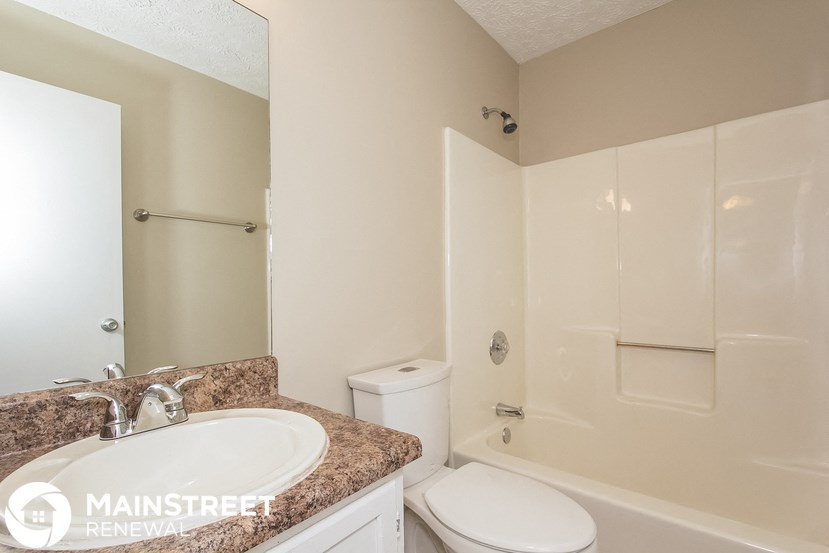 a bathroom with a sink and a toilet and a shower