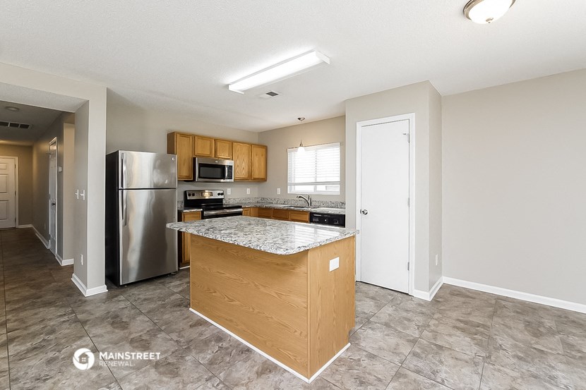 a kitchen with stainless steel appliances and a granite counter top