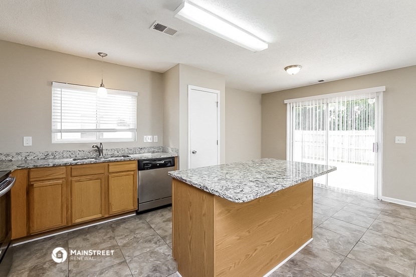 a kitchen with granite counter tops and stainless steel appliances