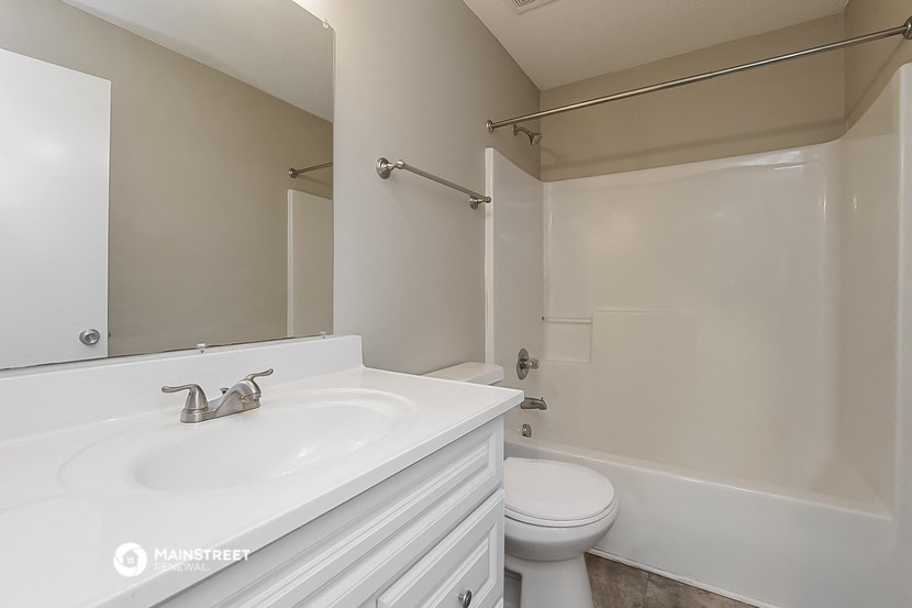 a bathroom with a sink and a toilet and a shower