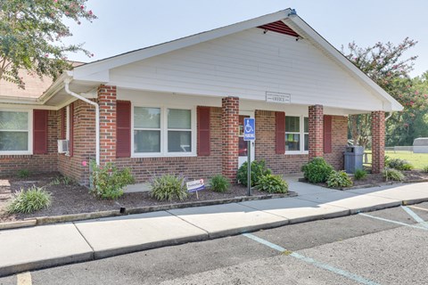 A small building with a white roof and a sign that says "Office" on it.