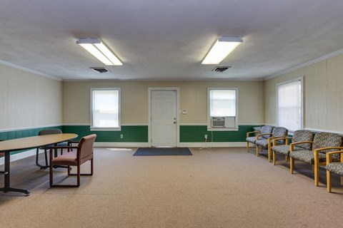 A room with a table and chairs.