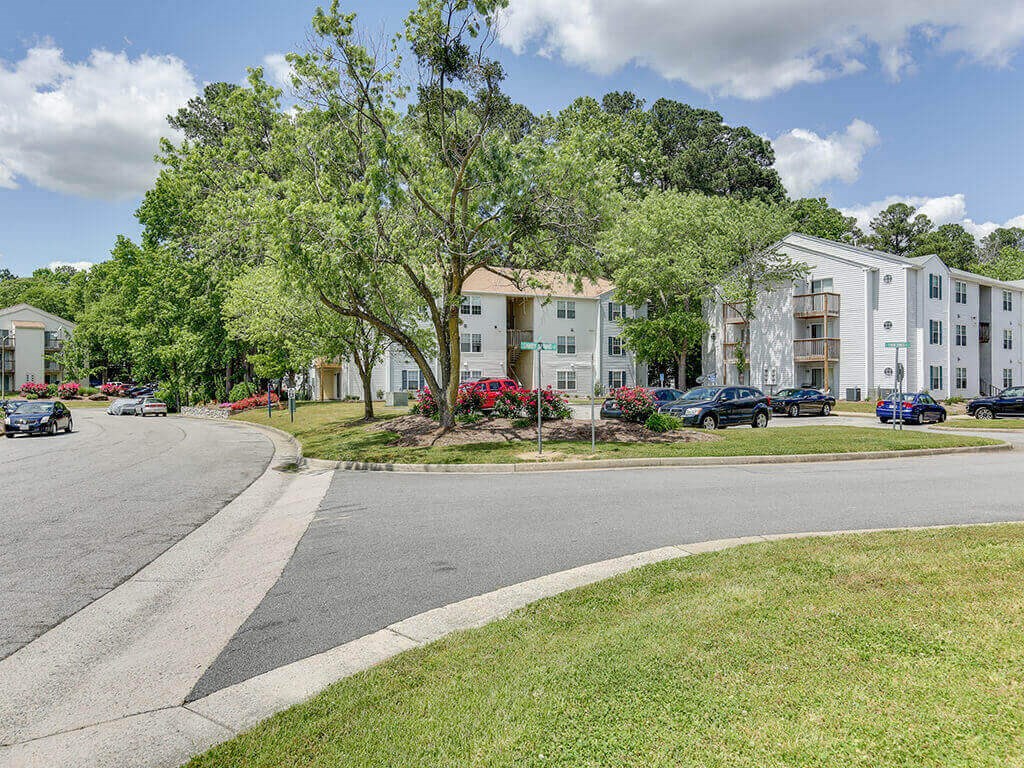 a street with apartment buildings on the side of a road