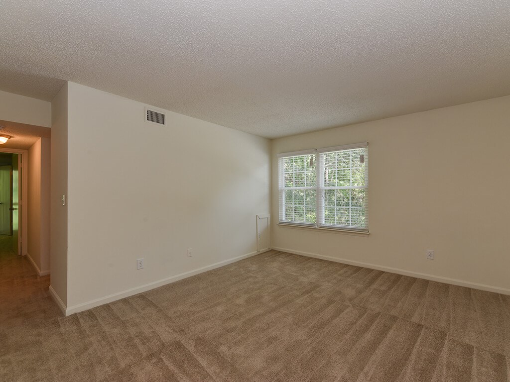the living room of an empty house with a window
