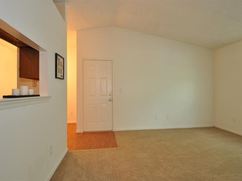 an empty living room with a white door