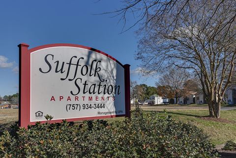 a sign station apartments is shown in a yard