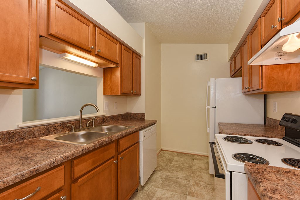 a kitchen with white appliances and granite counter tops
