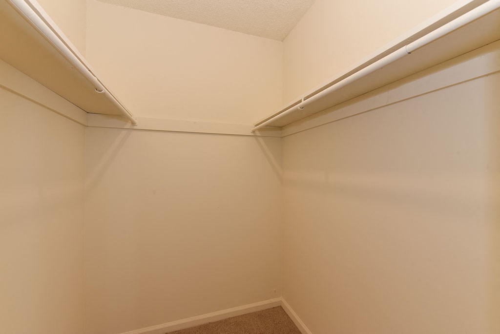 the corner of a room with a white wall and a window