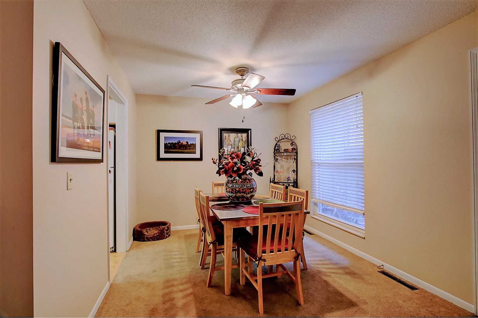 Image of dining room with table, chairs, and ceiling fan
