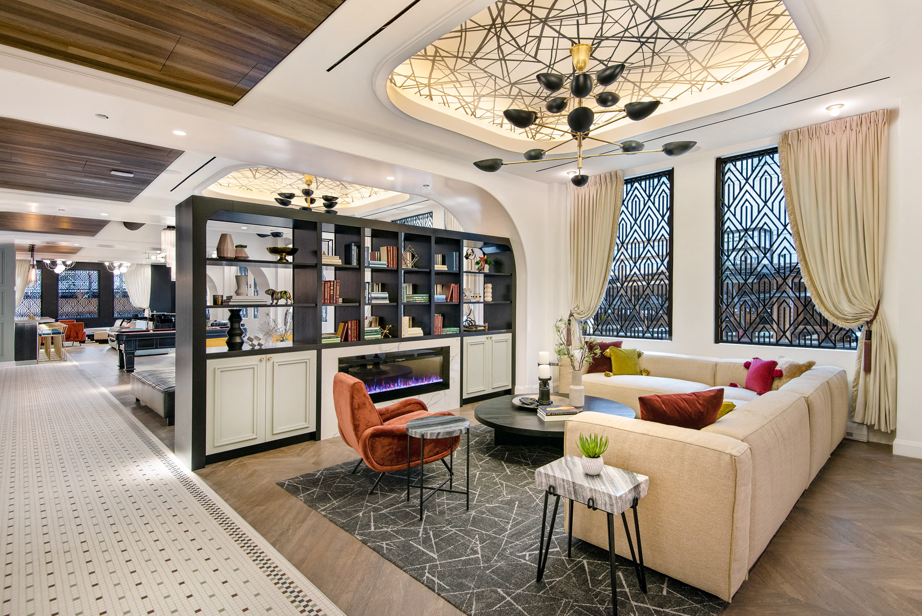 a living room with couches and chairs and a fireplace