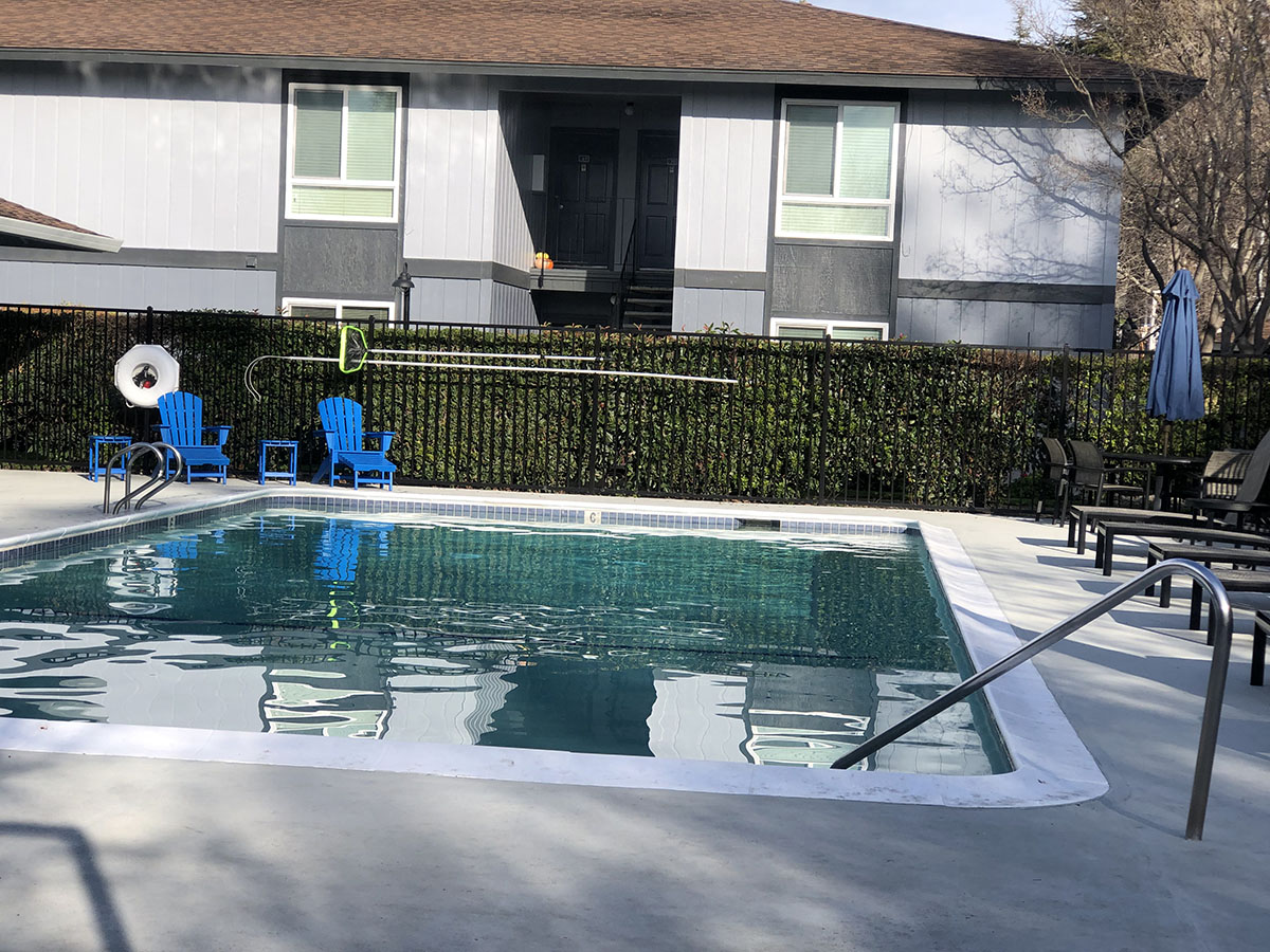 Exterior of building near pool with lounge chairs l Bella Vista Napa