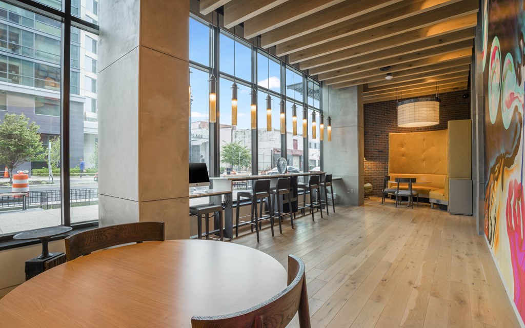 a large room with tables and chairs and large windows